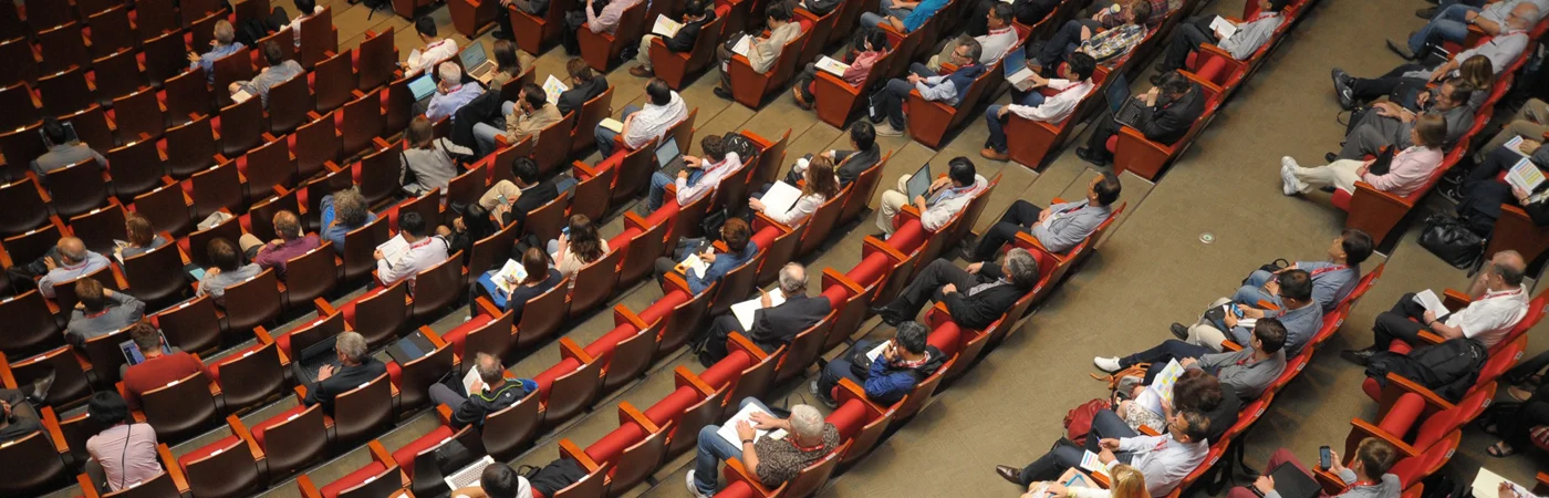Conference audience seated in rows facing the stage