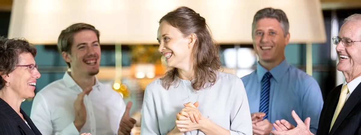 Group of business people laughing together at a networking event