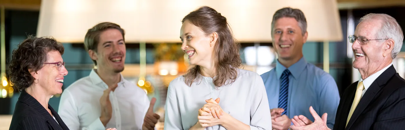 Group of business people laughing together at a networking event