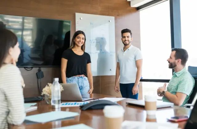 Colleagues discussing ideas around a conference table